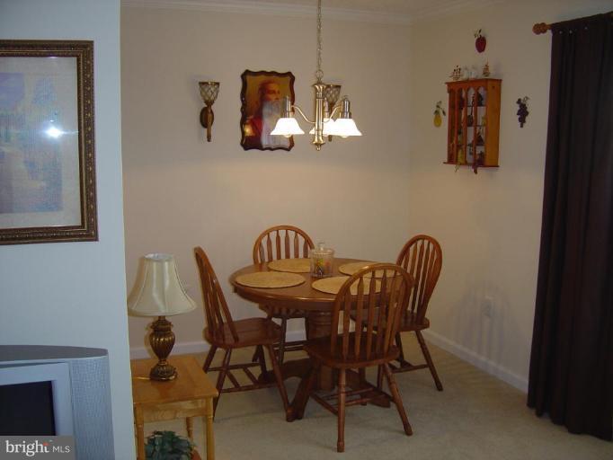 15653 Horseshoe Lane, Unit 653 Woodbridge, VA 22191 - Photo 7 of 7 a view of a dining room with furniture and wooden floor