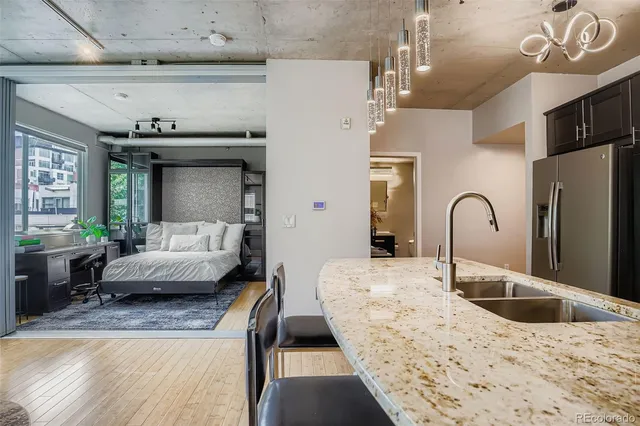 a bedroom with a bed and a large window