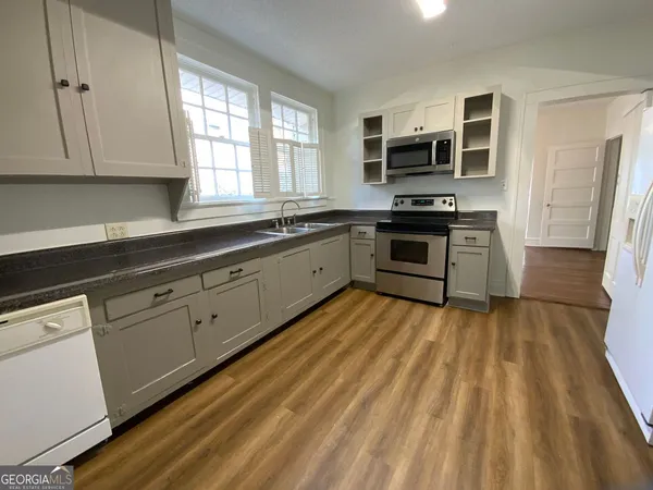 a kitchen with stainless steel appliances granite countertop a stove and a sink