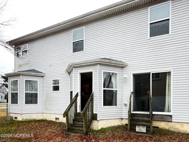 a view of a white house with many windows