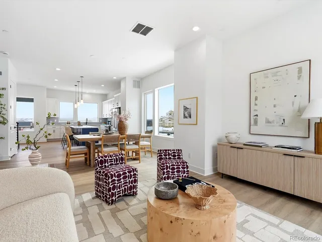 a kitchen with stainless steel appliances kitchen island granite countertop a stove a sink a refrigerator and white cabinets