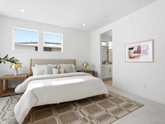 a spacious bedroom with a bed and a window