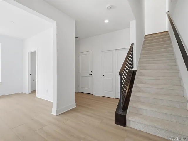 a view of entryway with wooden floor and stairs