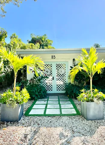 a view of a fountain in the garden with potted plants