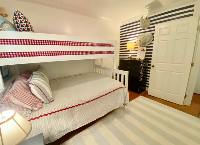 a bed sitting in a bedroom next to a bathroom