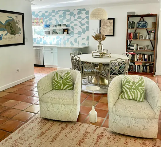 a living room with furniture and painting on the wall