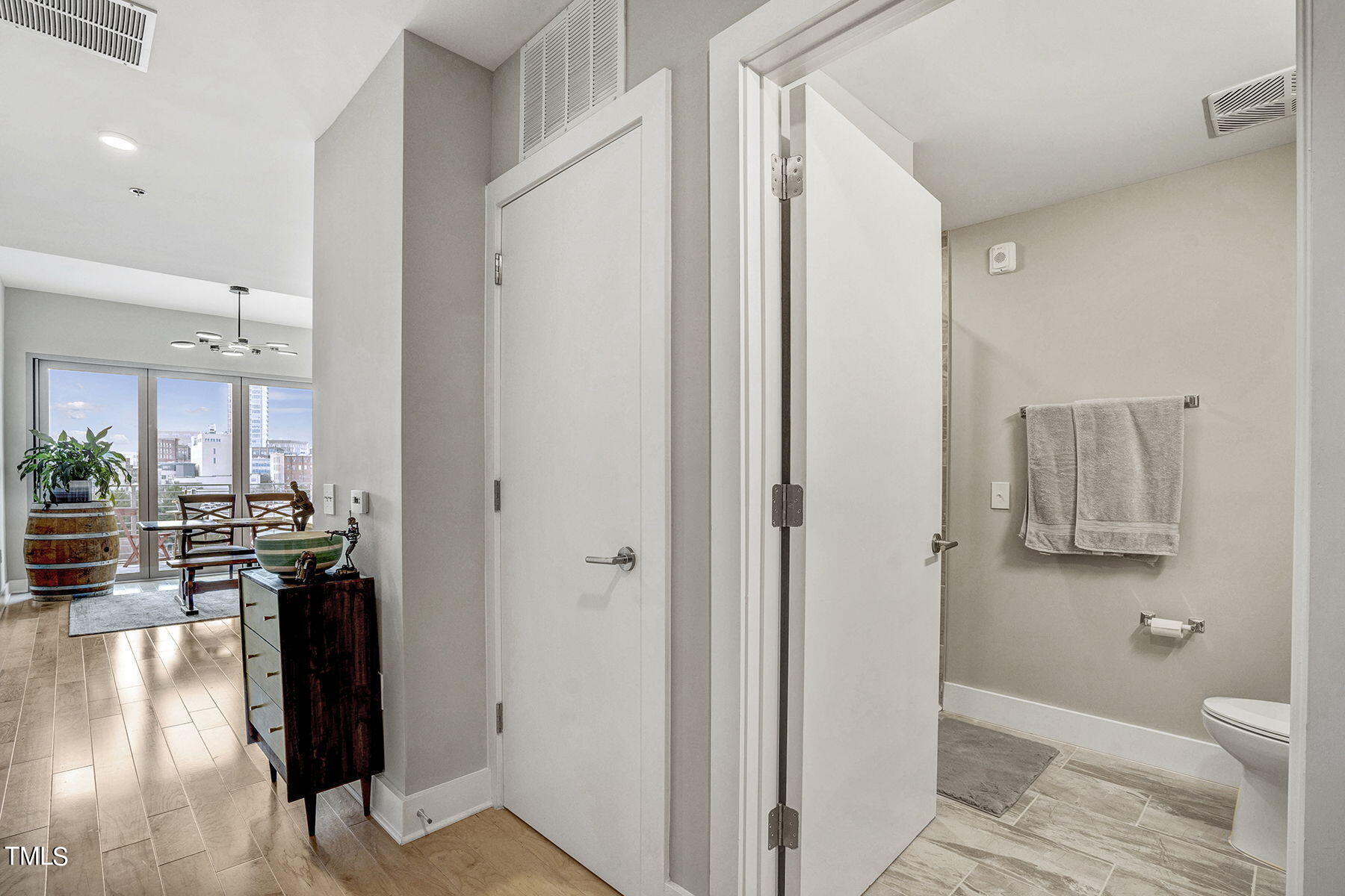 214 Hunt Street, Unit 711 Durham, NC 27701 - Photo 5 of 29 a view of a hallway with bathroom and wooden floor