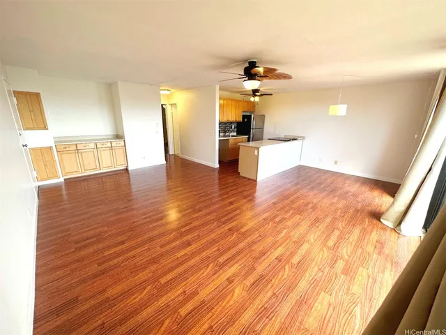 a view of a kitchen with wooden floor and a ceiling fan