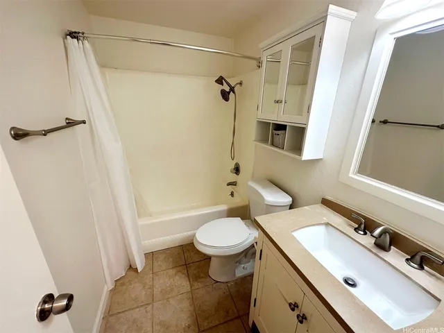a view of a room with wooden floor and a ceiling fan