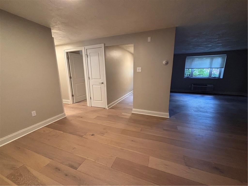 401 Shady Avenue, Unit B105 Pittsburgh, PA 15206 - Photo 2 of 8 an empty room with wooden floor and windows