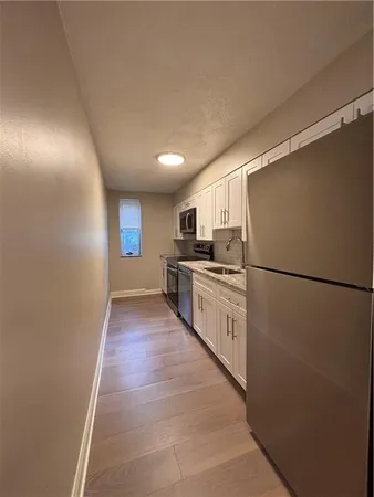 a kitchen with white cabinets and white appliances