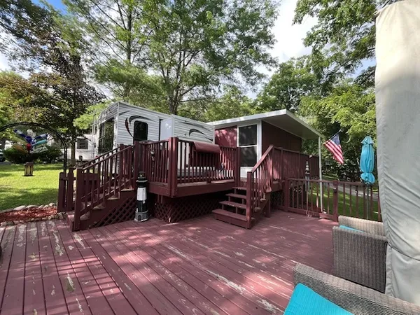 a view of a house with a yard deck and sitting area