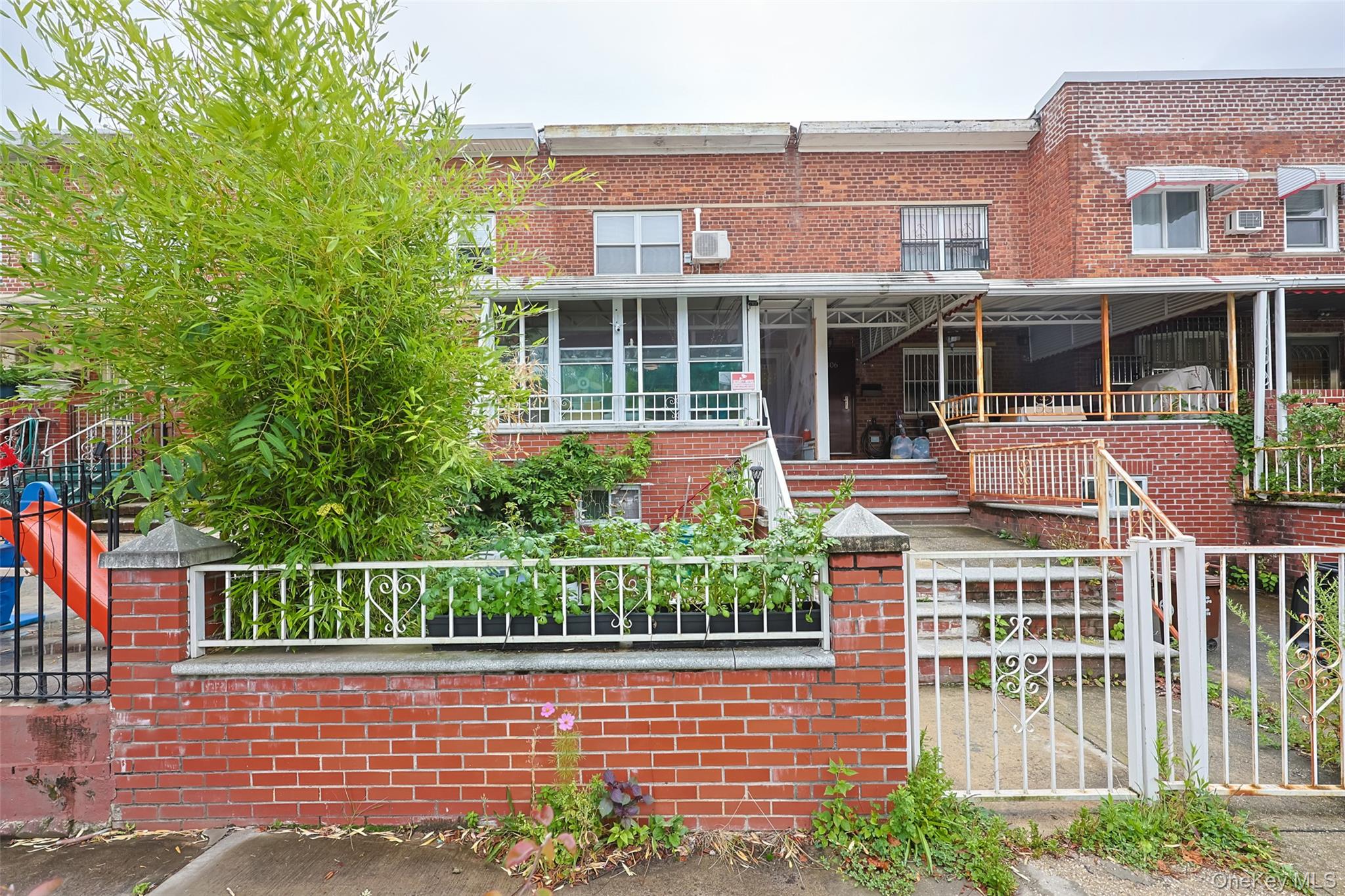 front view of a brick house with a large window