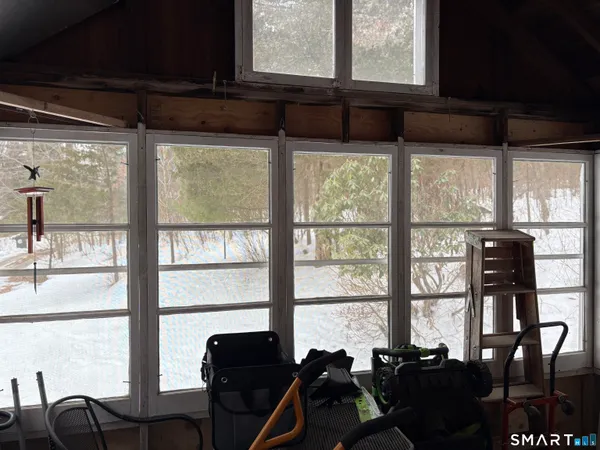 a living room with a large window and dining table