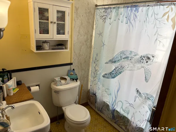 a white toilet sitting next to a bathroom sink
