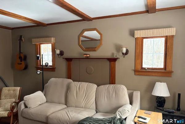 a living room with furniture and a mirror