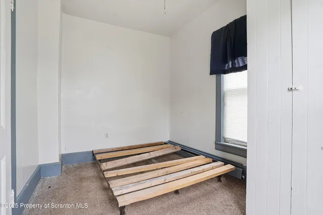 a bedroom with a bed and cabinets