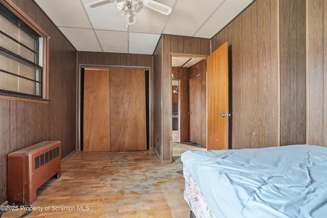 a bed room with a bed and a chair