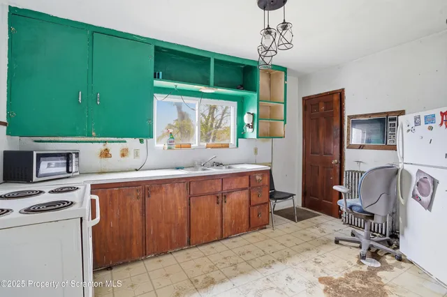 a kitchen with sink cabinets and window