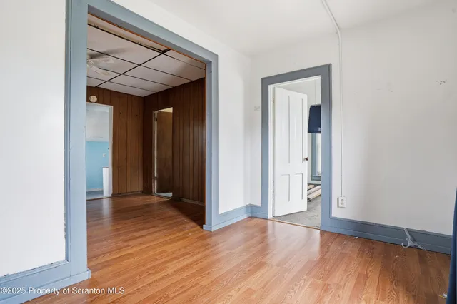 a view of hallway with wooden floor