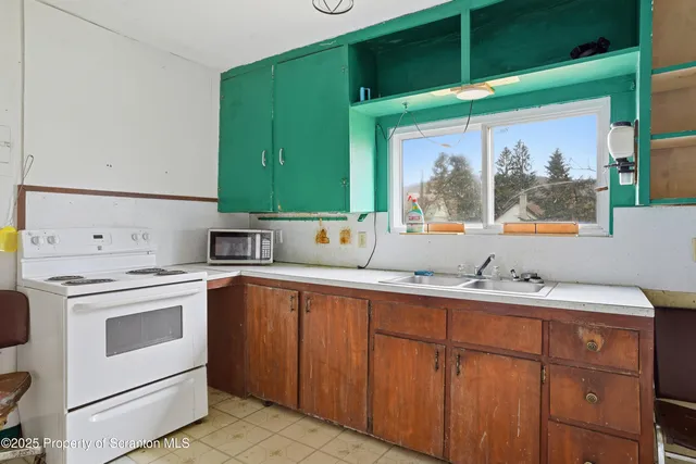 a kitchen with a sink stove and cabinets