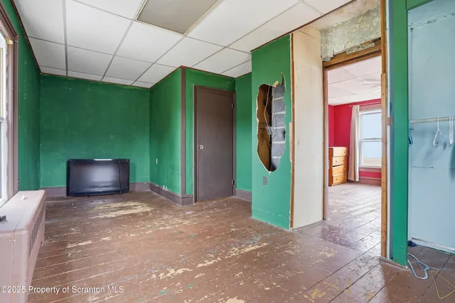 a view of a hallway with a door and windows