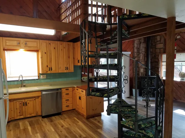 a kitchen with a sink cabinets and a window
