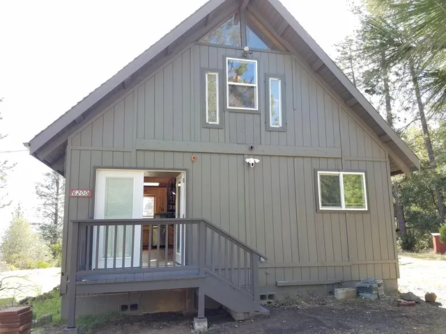 a view of backyard with deck and outdoor seating