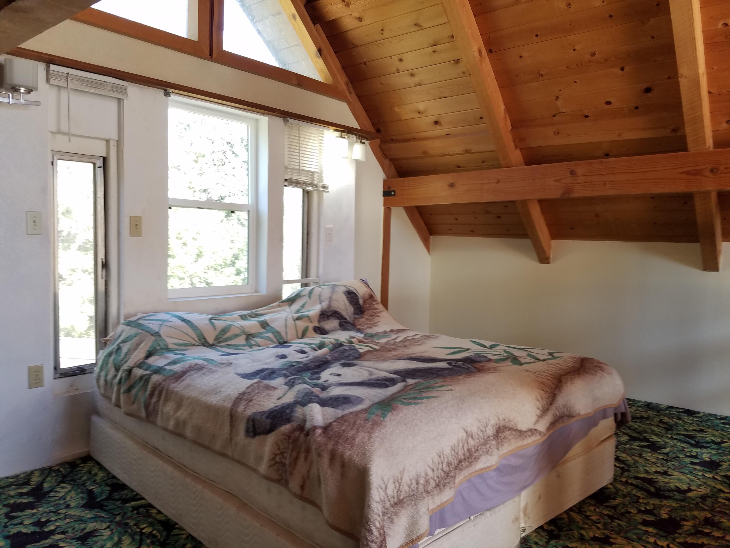 6200 Wilson Hill Road Shingletown, CA 96088 - Photo 35 of 53 a bedroom with a bed and a window