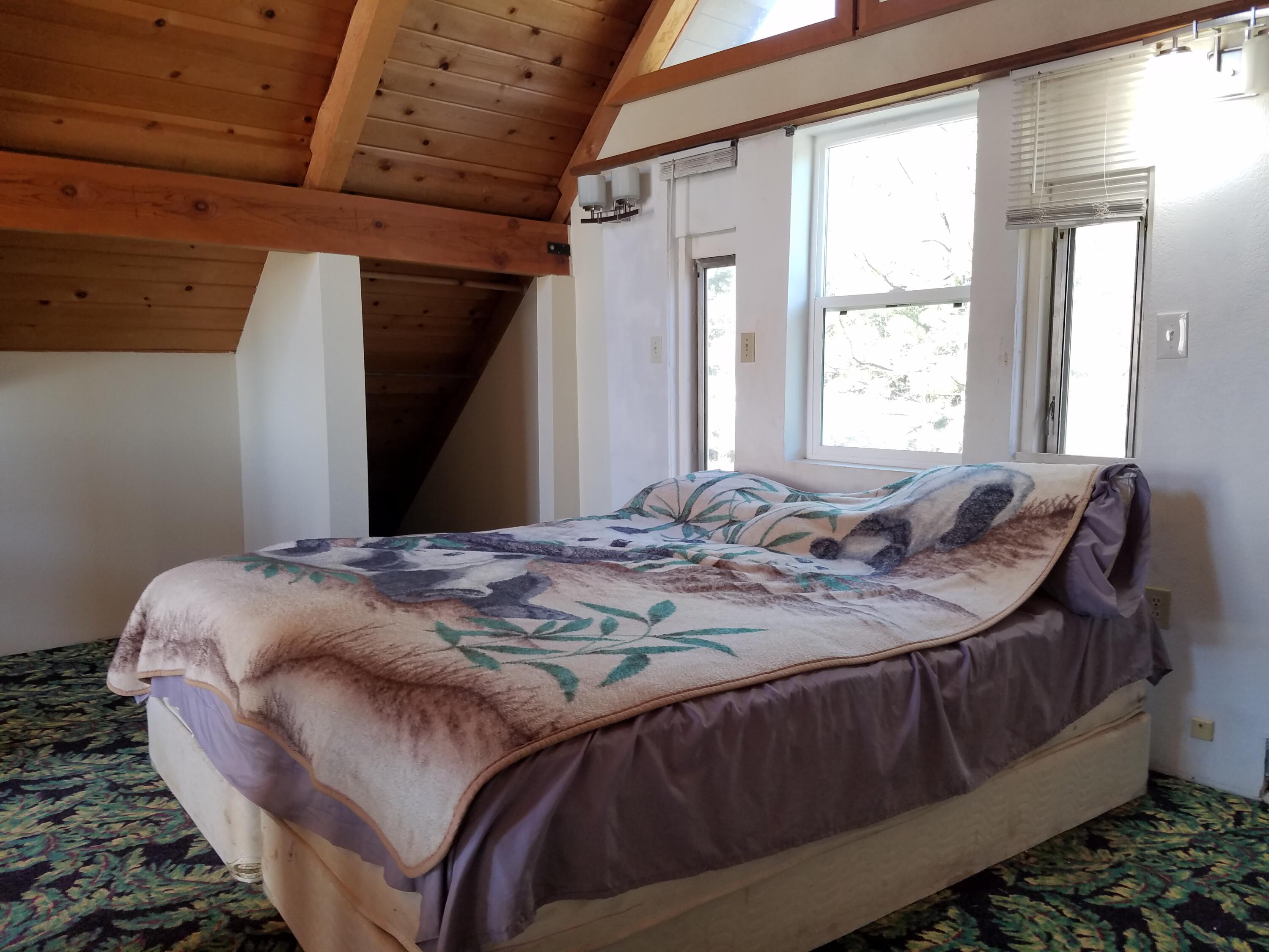 6200 Wilson Hill Road Shingletown, CA 96088 - Photo 36 of 53 a bed sitting in a bedroom next to a window