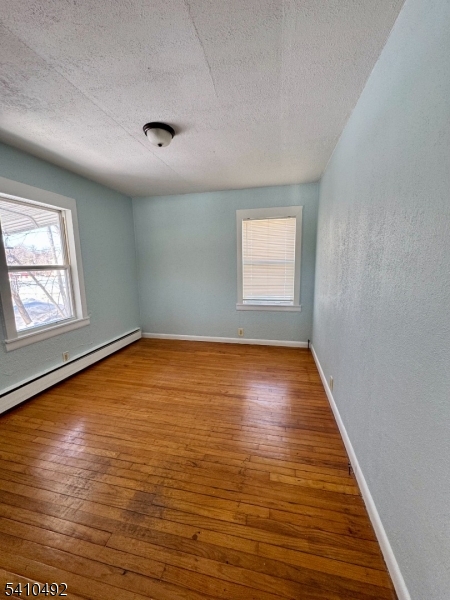 14 Glen Road Sparta, NJ 07871 - Photo 6 of 13 an empty room with wooden floor and windows