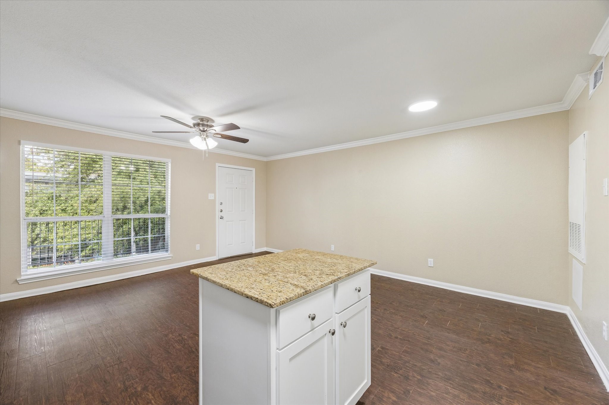 300 Pecore Street, Unit 19 Houston, TX 77009 - Photo 6 of 10 an empty room with a exposed radiator and wooden floor