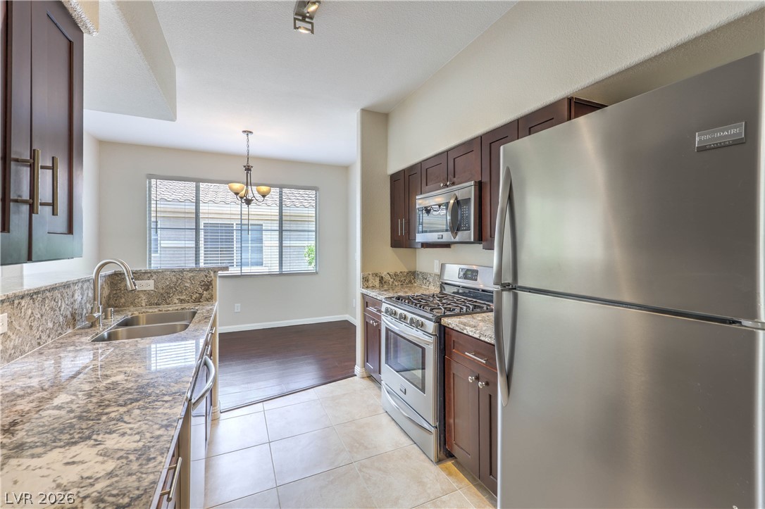9050 West Warm Springs Road, Unit 2033 Las Vegas, NV 89148 - Photo 10 of 30 Culinary delights await in this modern kitchen with ample counter space and integrated dining.