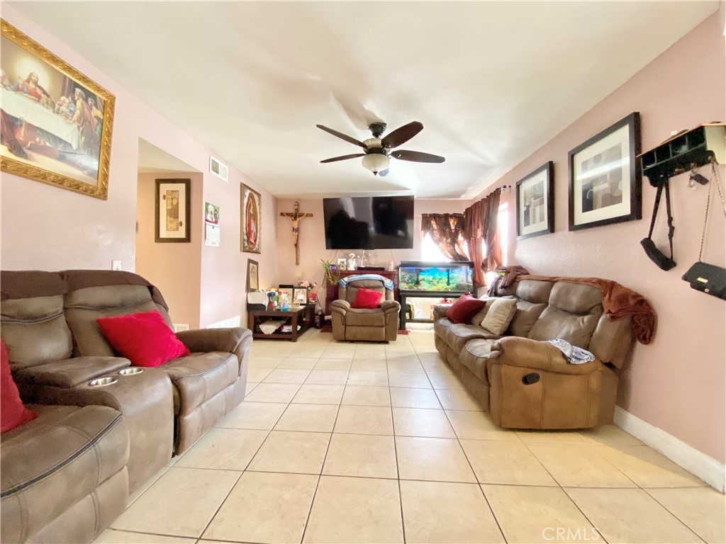 1444 North Sage Avenue Rialto, CA 92376 - Photo 9 of 22 a living room with furniture and a chandelier