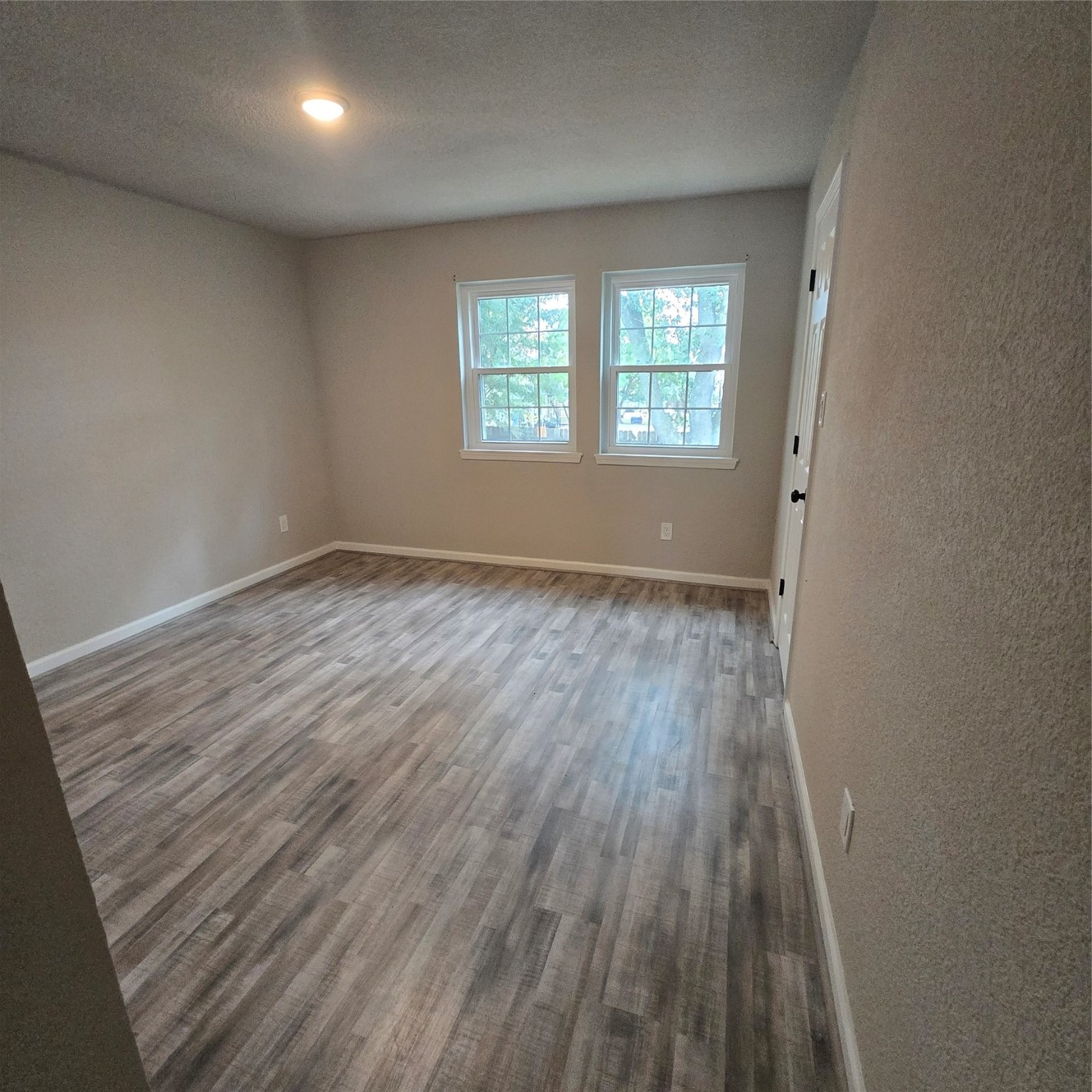 8355 Nairn Street Houston, TX 77074 - Photo 14 of 21 an empty room with wooden floor and windows