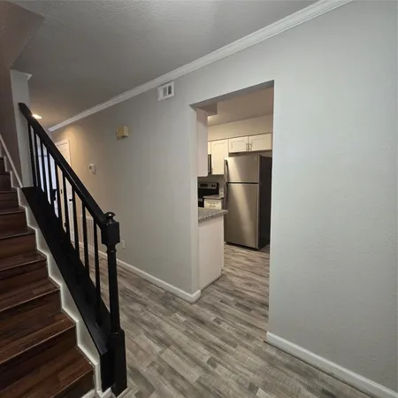 a view of a kitchen with a sink and refrigerator
