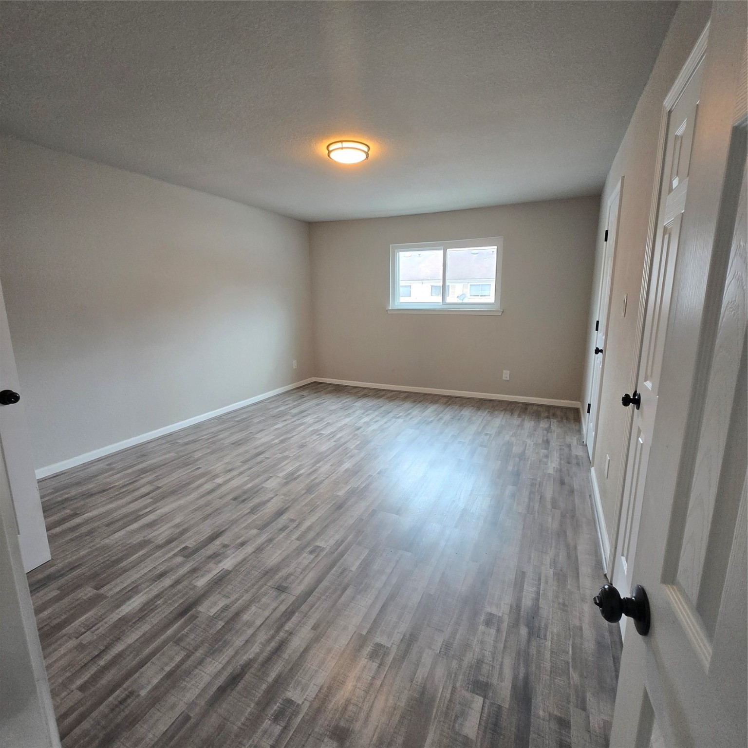8355 Nairn Street Houston, TX 77074 - Photo 9 of 21 an empty room with wooden floor and windows