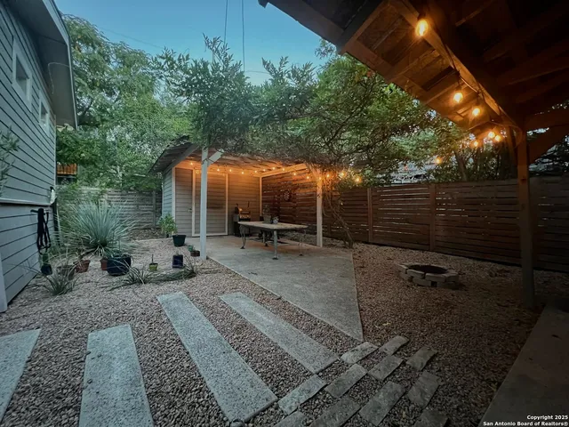 a view of a backyard with sitting area