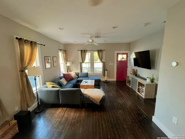 a living room with furniture and a flat screen tv