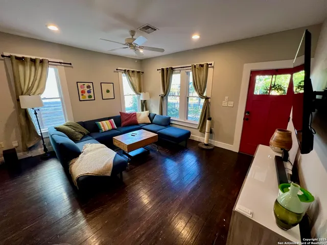 a living room with furniture window and wooden floor