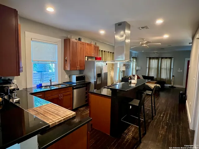 a kitchen with a table chairs and a refrigerator