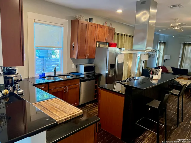 a kitchen with a refrigerator and a stove top oven