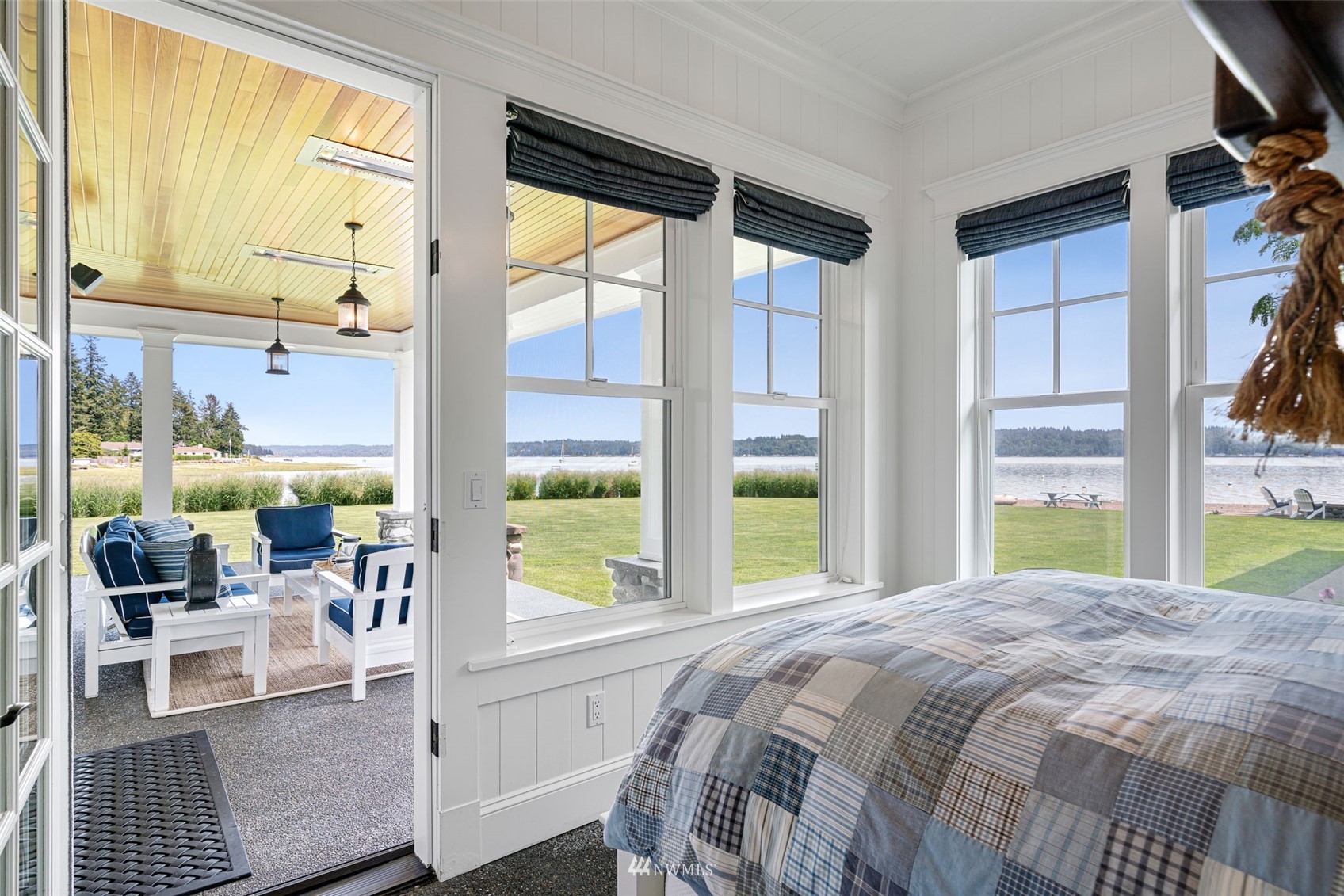 6797 Northeast North Shore Road Belfair, WA 98528 - Photo 13 of 40 a bedroom with a bed and a large window with outer view