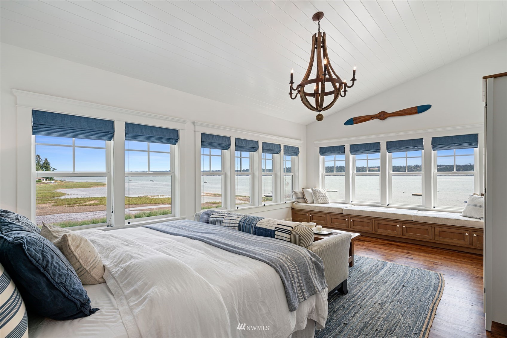 6797 Northeast North Shore Road Belfair, WA 98528 - Photo 17 of 40 a bedroom with a bed next to a large window with a large window