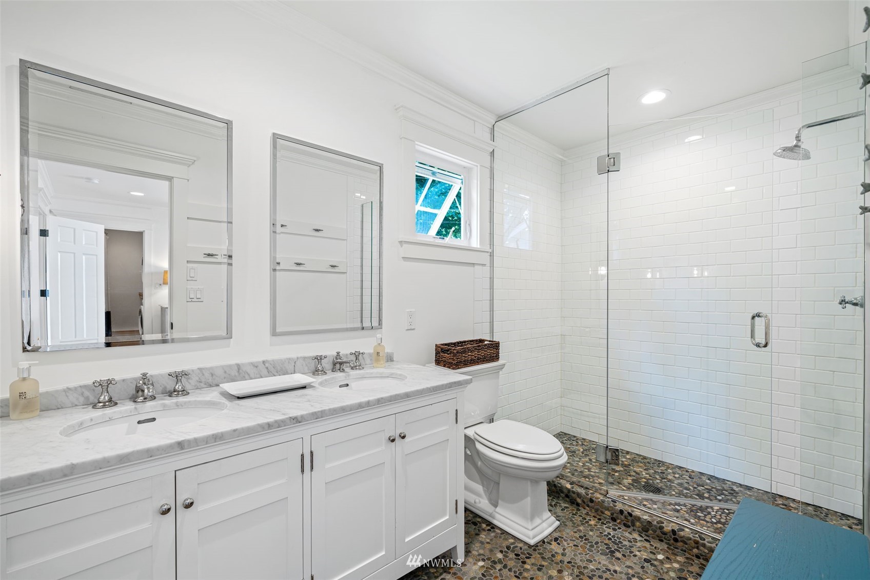 6797 Northeast North Shore Road Belfair, WA 98528 - Photo 30 of 40 a bathroom with a granite countertop sink toilet a large mirror a shower and a mirror