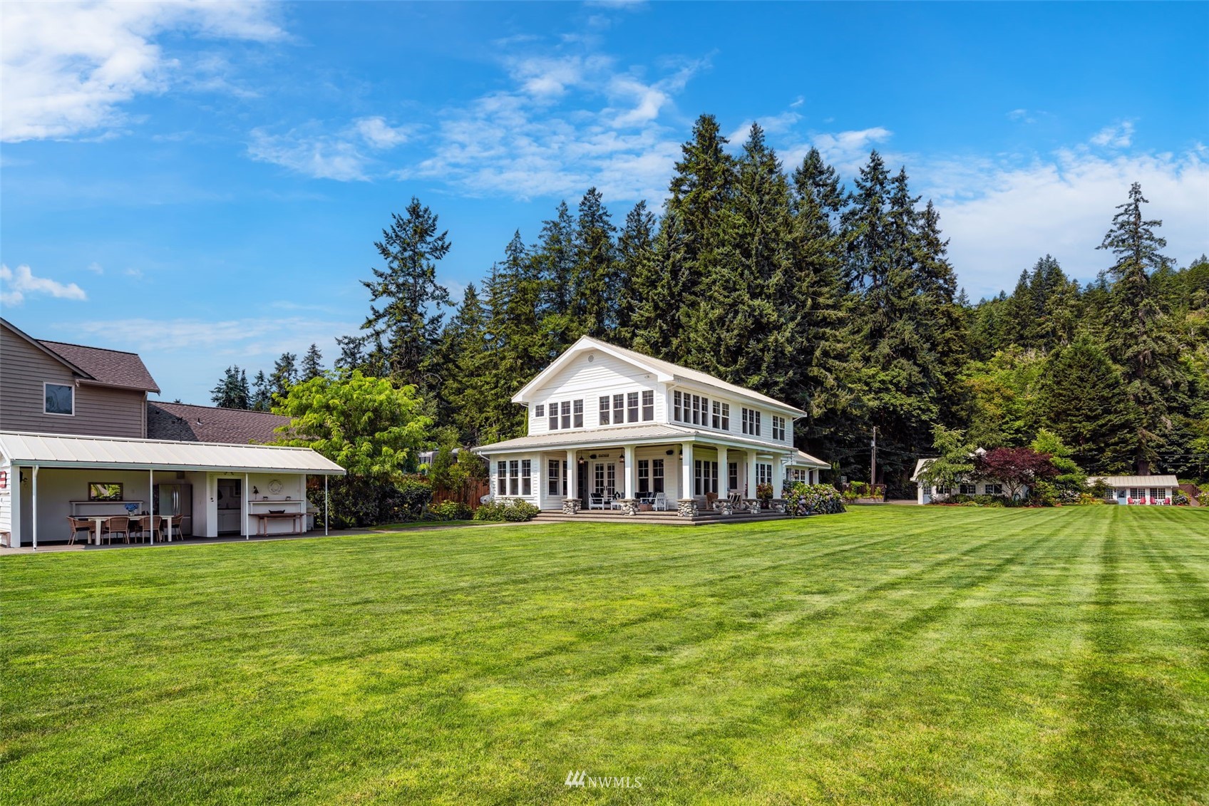 6797 Northeast North Shore Road Belfair, WA 98528 - Photo 37 of 40 a front view of a house with a yard