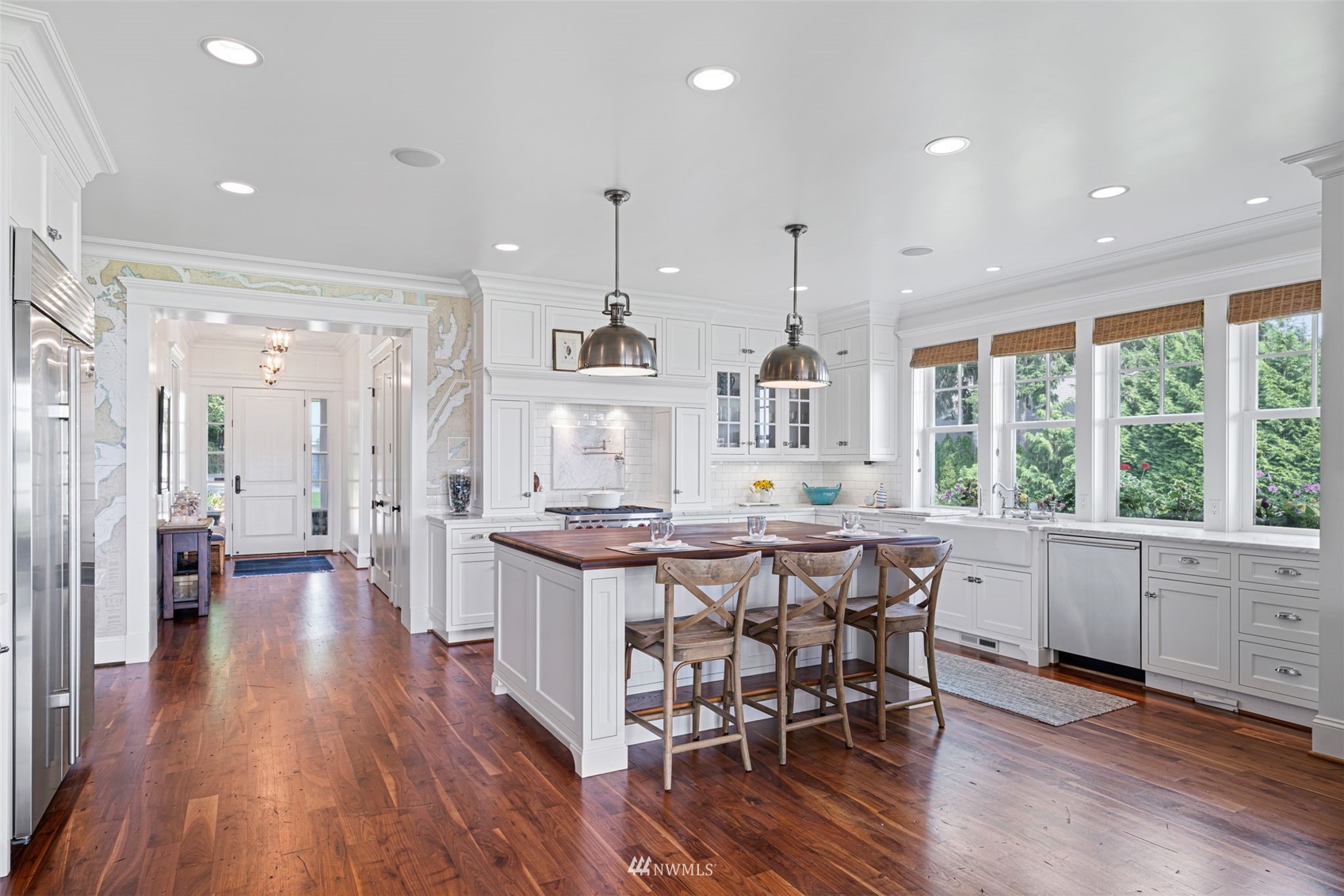 6797 Northeast North Shore Road Belfair, WA 98528 - Photo 5 of 40 a kitchen with stainless steel appliances granite countertop a table chairs stove and wooden floor