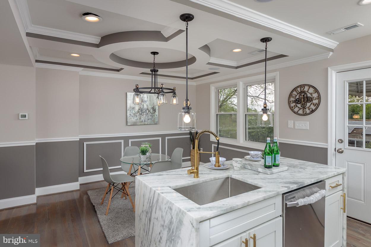 5923 Falkirk Road Baltimore, MD 21239 - Photo 11 of 27 a kitchen with a sink a chandelier and living area view