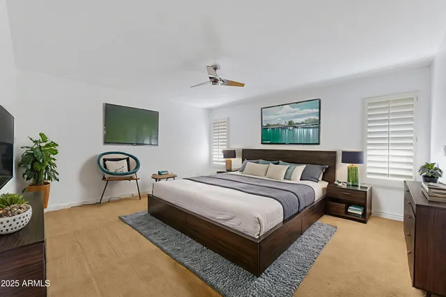 an empty room with windows and ceiling fan