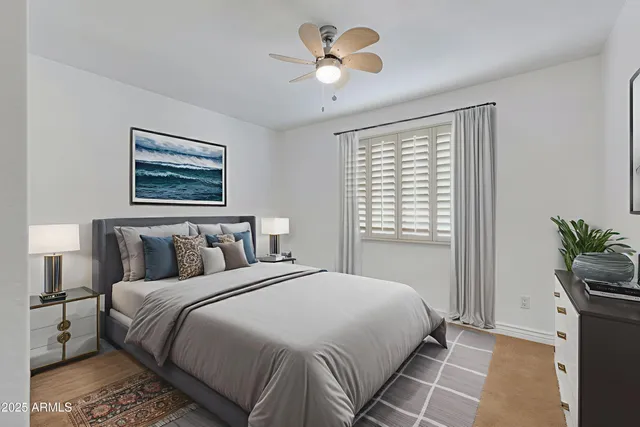 an empty room with a window and a fan